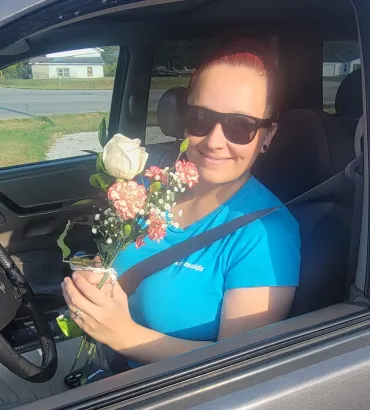 merry maids team member holding flowers